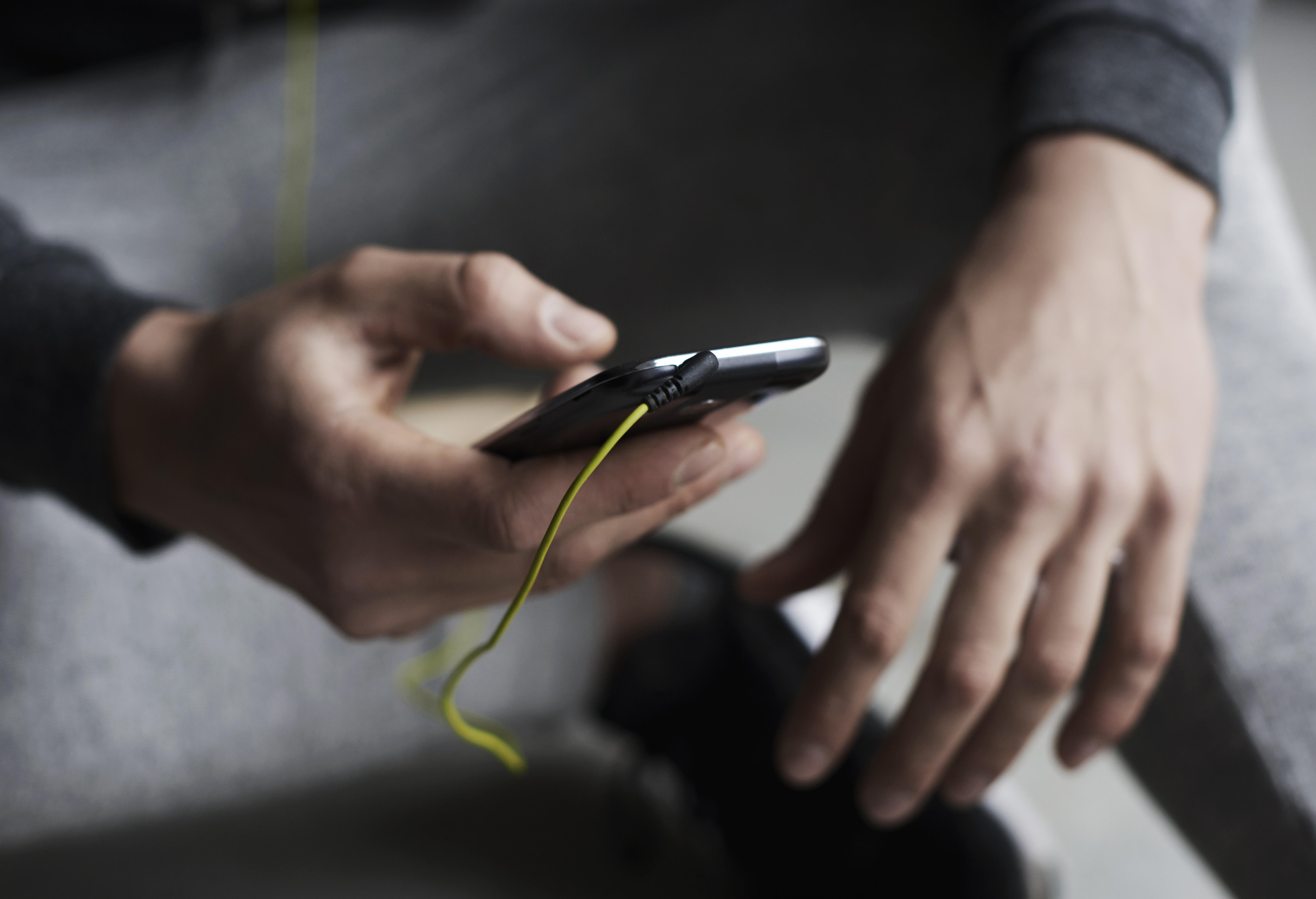 Close up hands choosing song phone